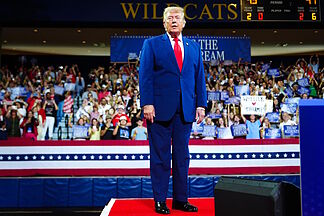 Three attendees at a Trump rally troll him behind his back during his speech